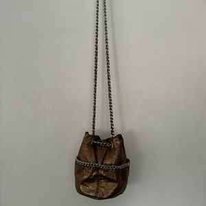 A bronze metallic material shoulder bag.